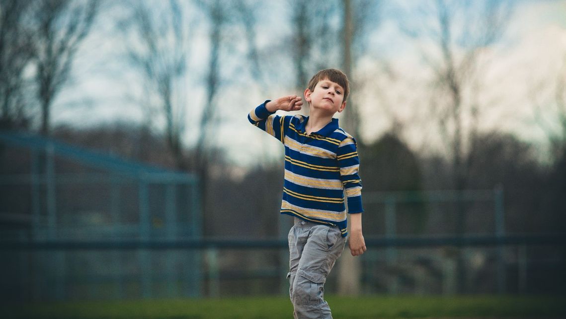 autistic child playing on a field